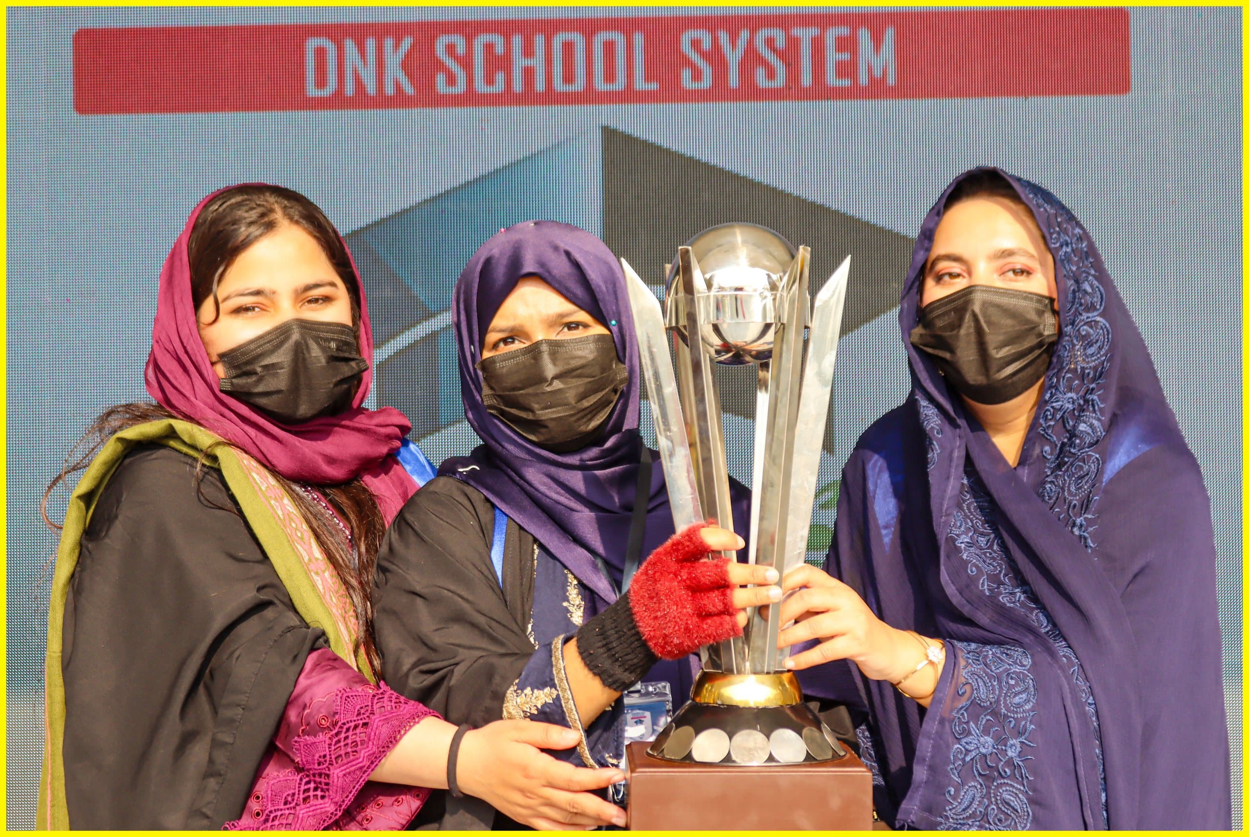 Staff and students with a trophy at a school event