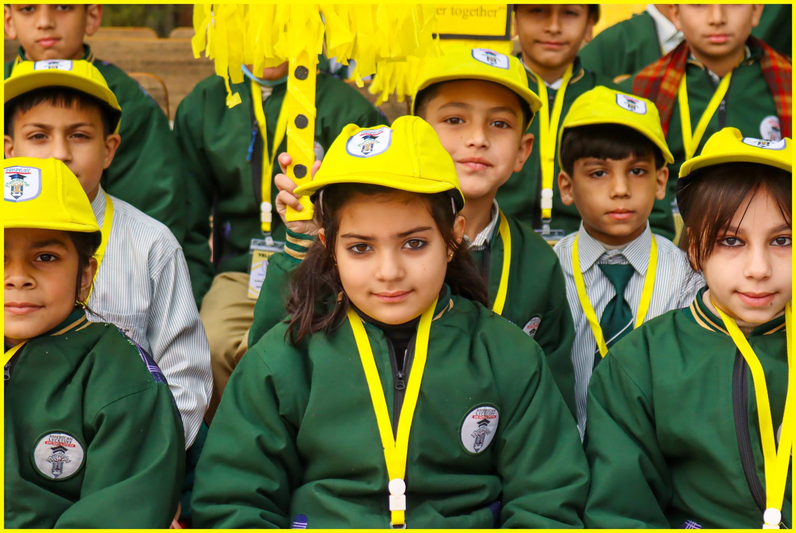 Students in yellow caps at the American Lycetuff Swabi campus