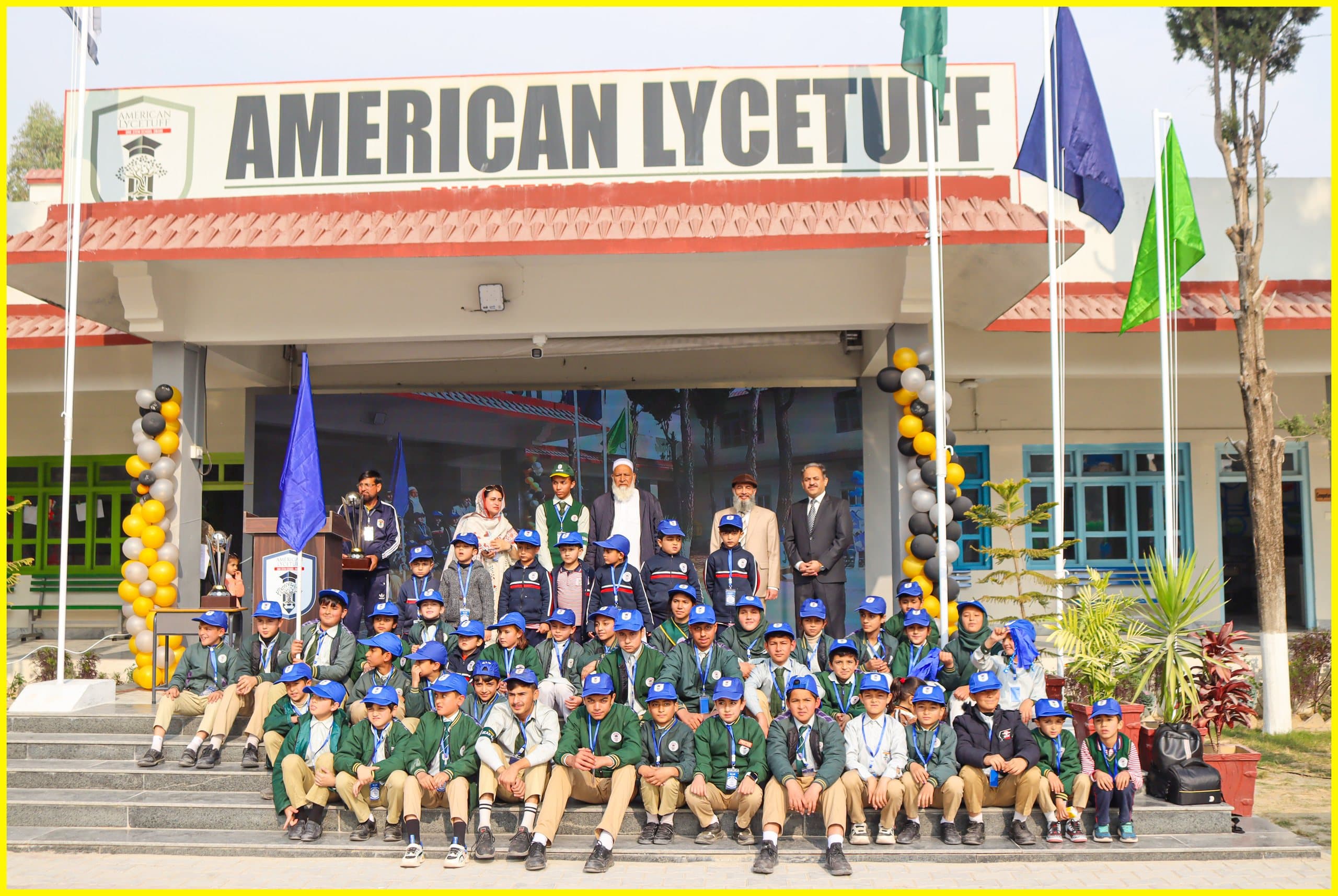 Students and staff at a morning assembly in front of the American Lycetuff Swabi campus