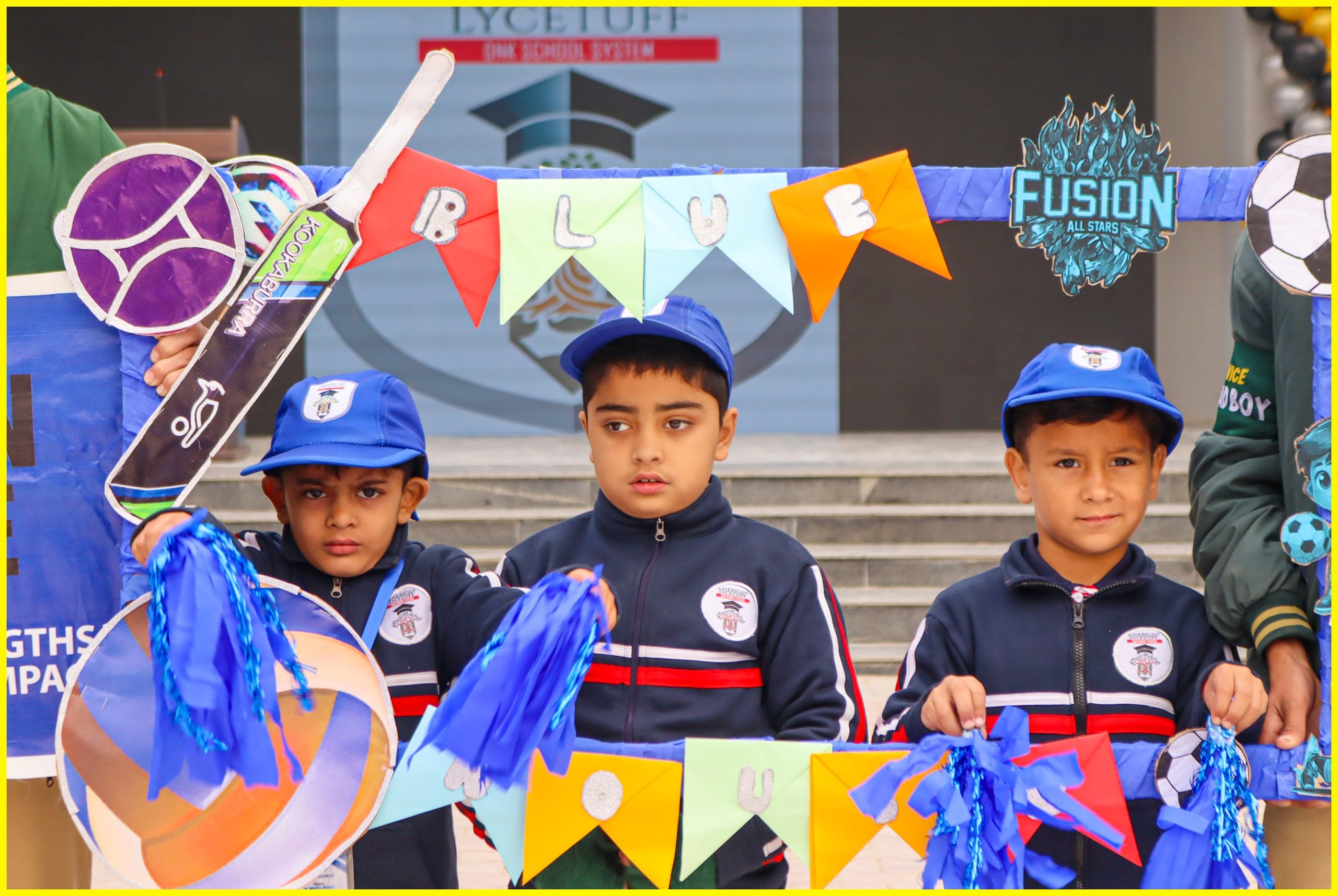 Early years pupils in blue caps at a school celebration