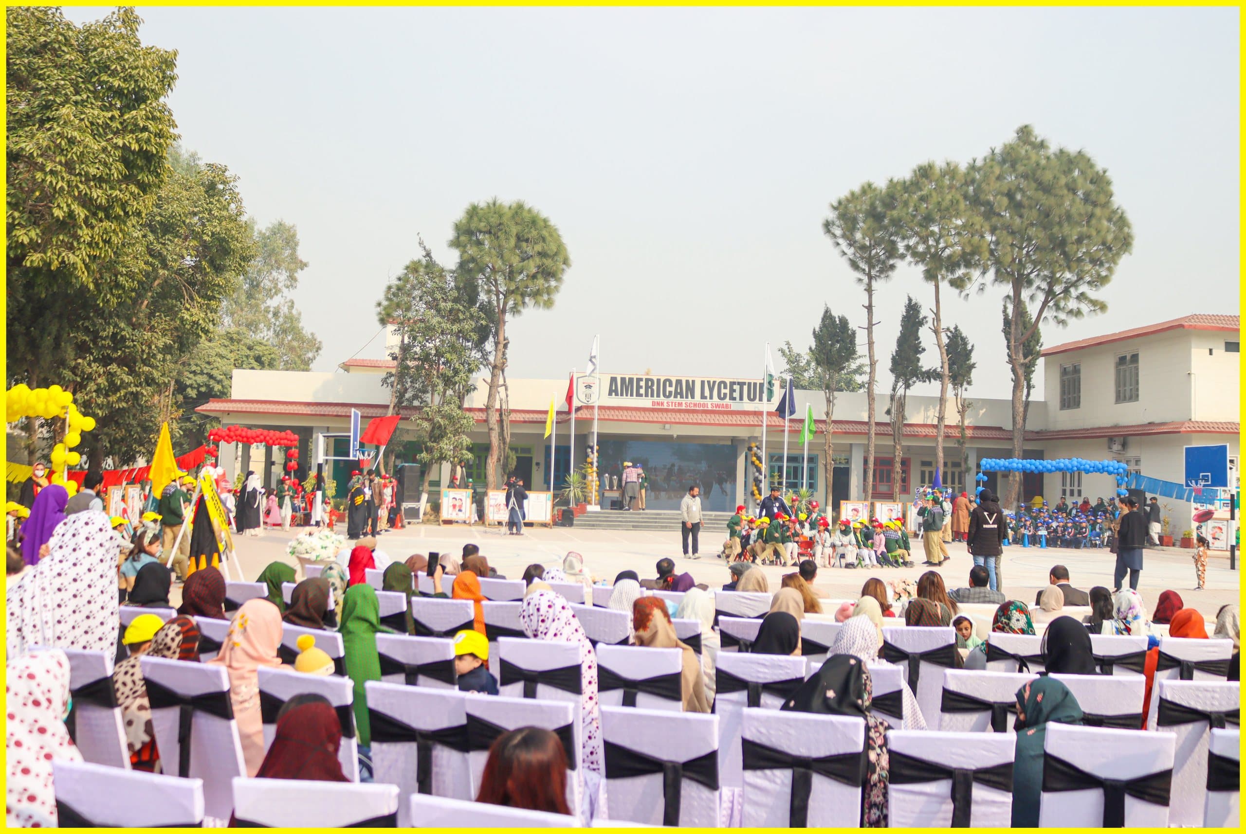 Students and families gathered in front of the American Lycetuff Swabi campus building for a school event