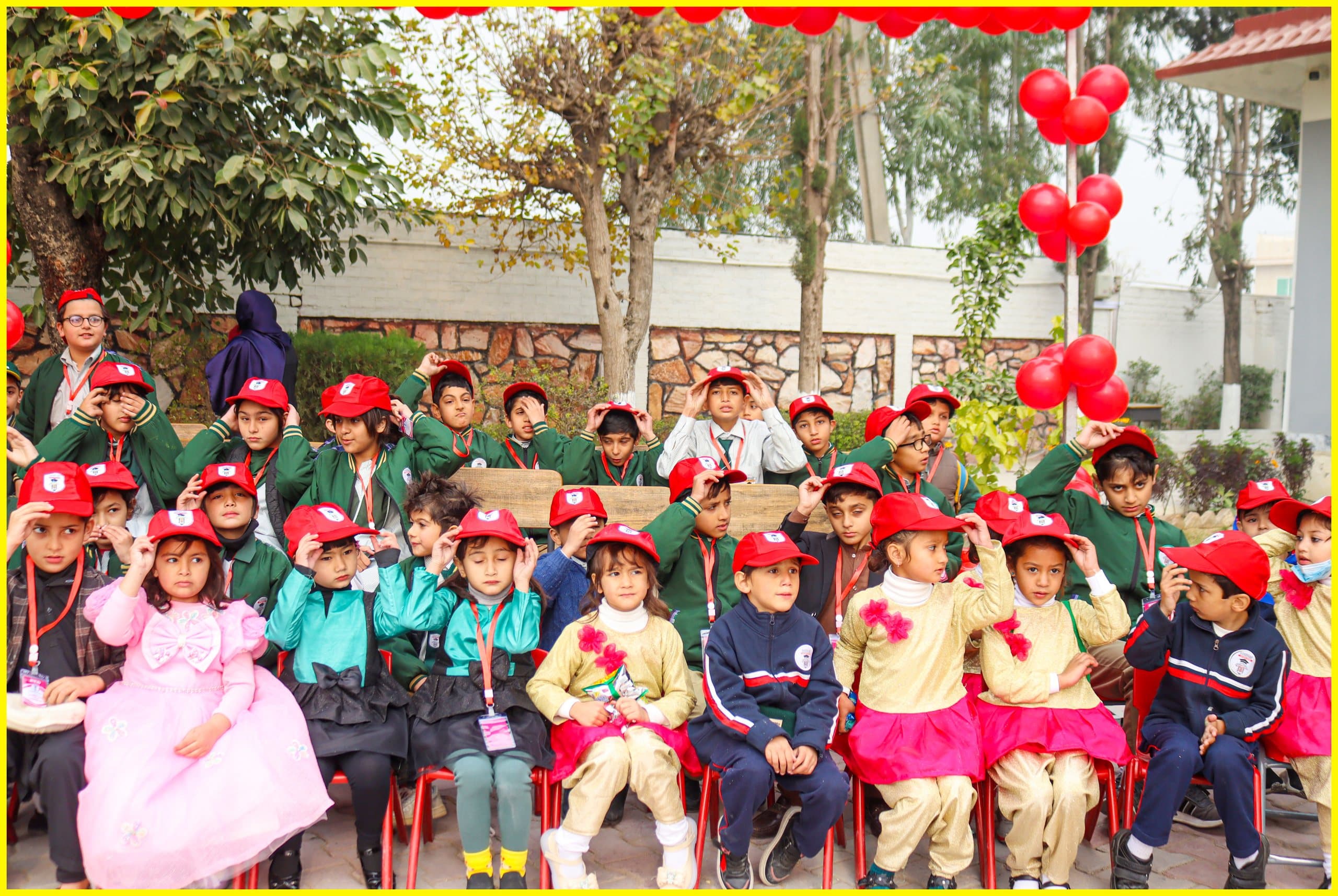 Young students in red caps gathered for a school event