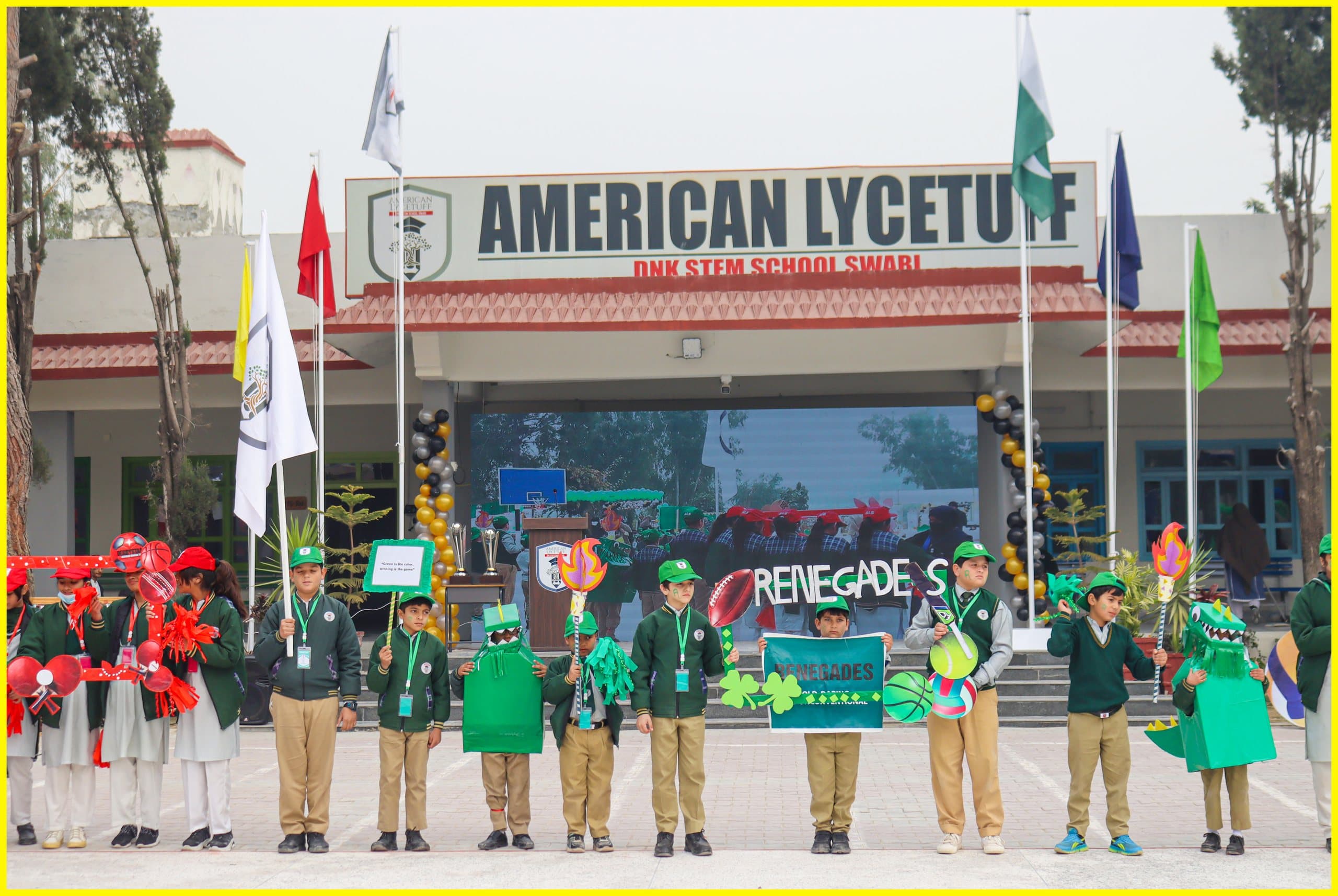 Students in green uniforms lined up outside the American Lycetuff Swabi campus entrance