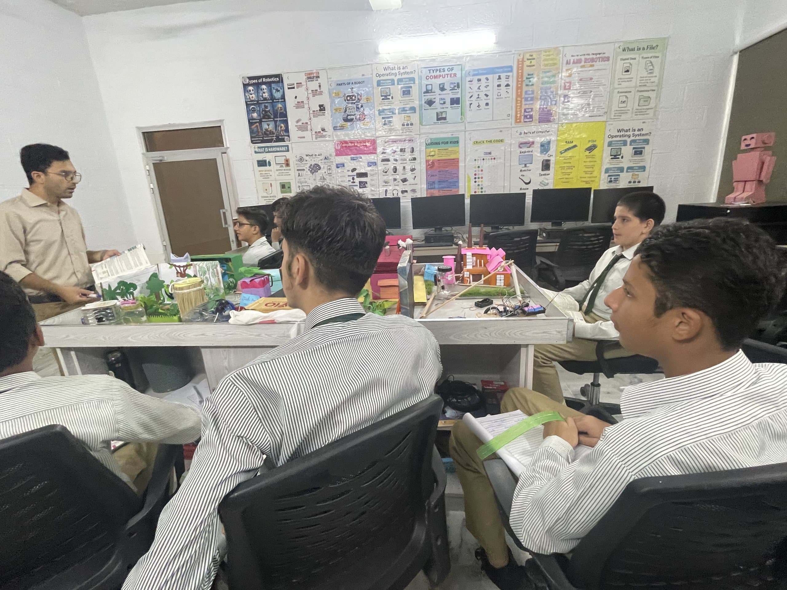 Students working at computers in the robotics and programming lab