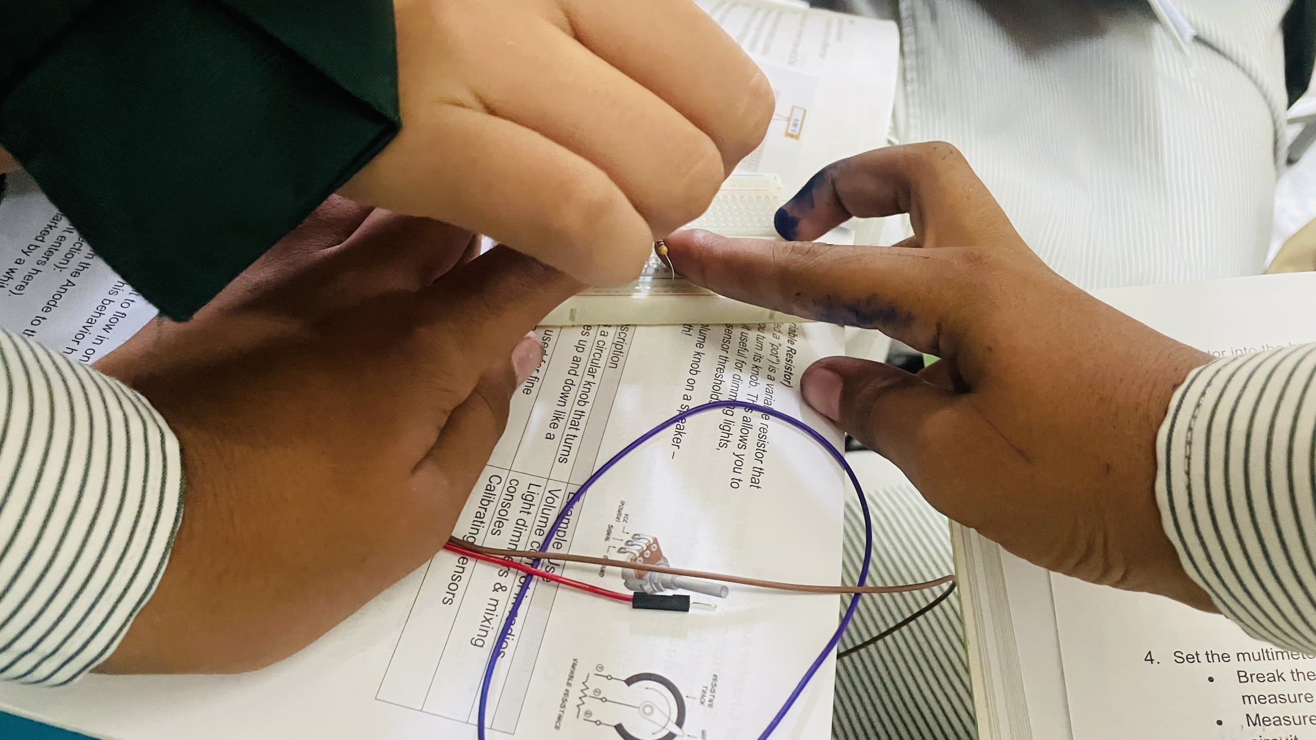 Senior students wiring components for an advanced electronics project